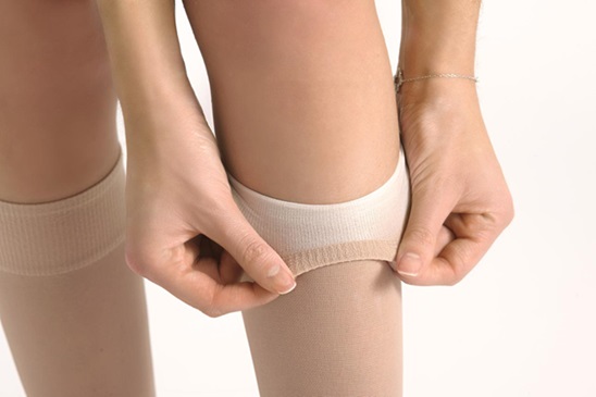 Person wearing graduated compression stockings to improve circulation and reduce leg fatigue.